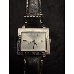 Coach watch a silver-tone logo etched around the bezel